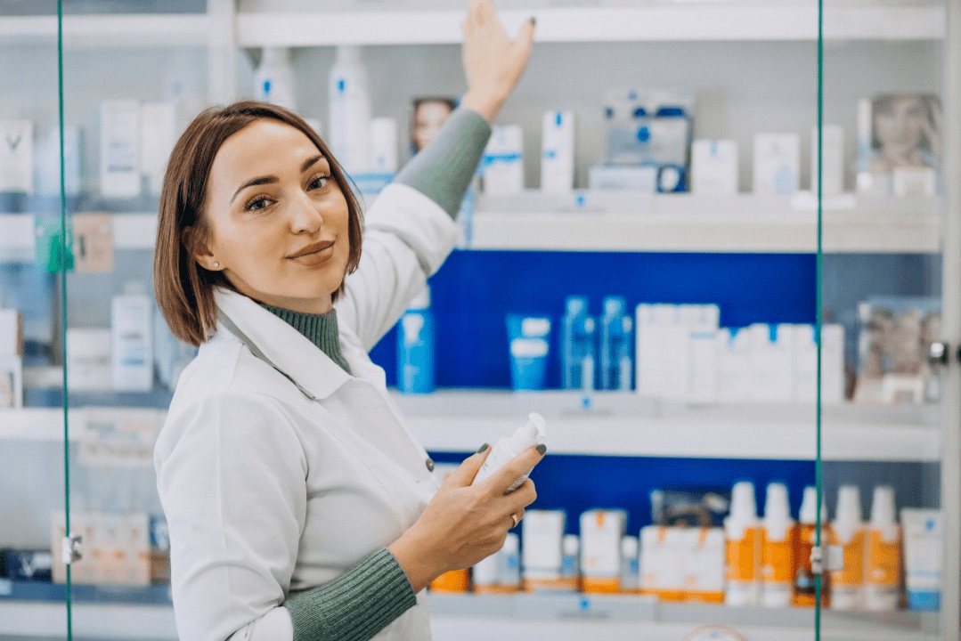 A woman holding onto some medicine in her hand